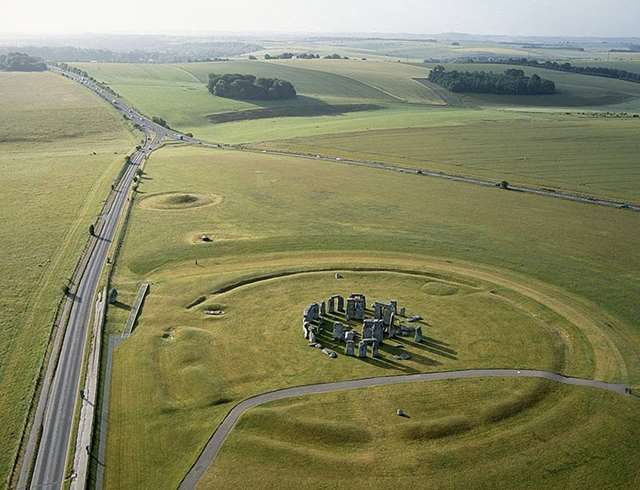 Aerial image of Stonehenge, showing the highway and road running past it and the small road running right through the circle.